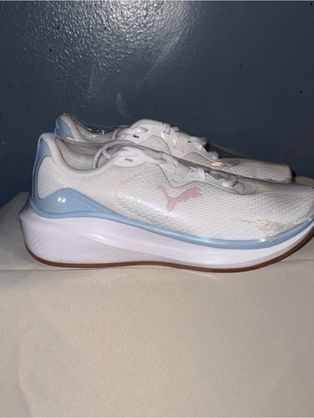 Puma White Sneakers with Light Blue Trim and Pink Logo